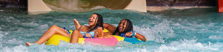 Two women on an inner tube at the  Indoor WaterPark